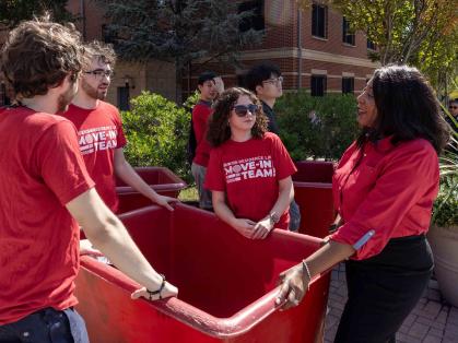 Rutgers-New Brunswick Chancellor Francine Conway (right) speaks with student members of the Residence Life move-in team Monday outside BEST Hall.