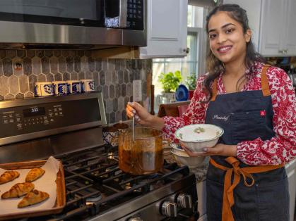 Rutgers senior Prachi Shashidhar serves up soup in her parents' kitchen.