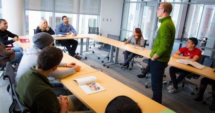 Faculty meet in a conference room.