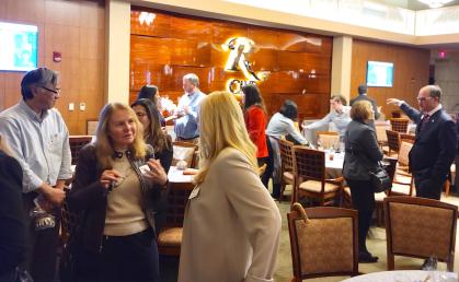 Attendees talk during a speed networking event at the Rutgers Club