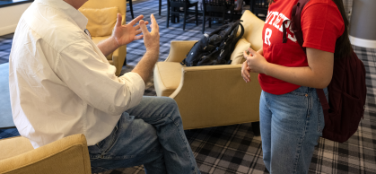 A faculty member speaking with a student