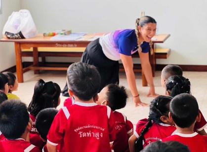 Chelsea A. Fernandez, a Rutgers graduate and Fulbright grant recipient, plays animal charades for school children in Thailand.