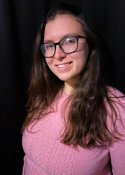 Woman with a pink shirt and long brown hair