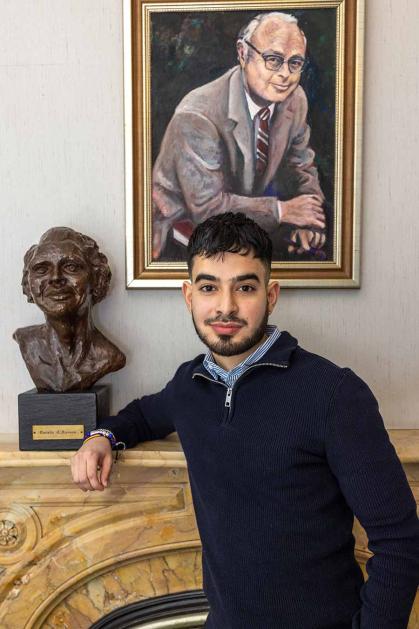 Rafael Escalante, a junior at Rutgers-New Brunswick, poses at a fireplace in Wood Lawn Mansion.
