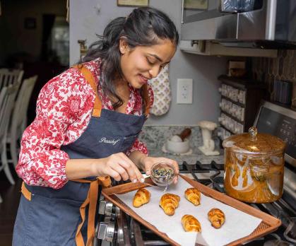 Rutgers senior Prachi Shashidhar adds garnish to croissants in her parents' kitchen.
