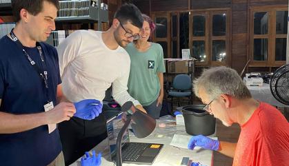 Four scientists study DNA in a field lab