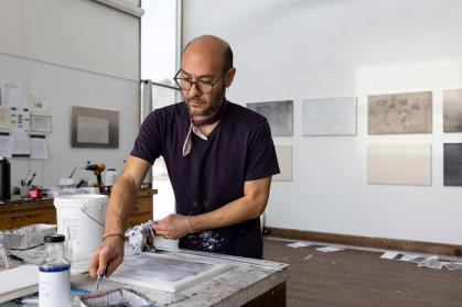 Marc Handelman works in a studio at Surf Point on the coast of Maine as part of a residency program.
