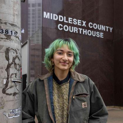 Rutgers senior Stephanie Gomez-Vanegas poses outside the Middlesex County Courthouse in New Brunswick, N.J.