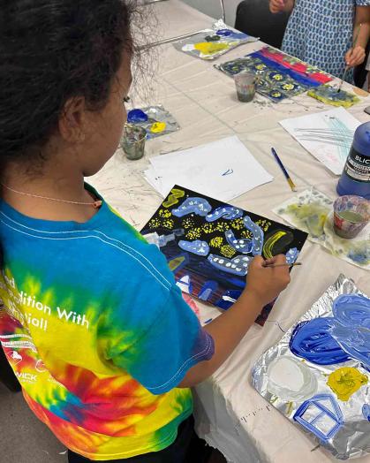 A child paints during the Zimmerli Art Museum's 2023 Summer Art Camp.