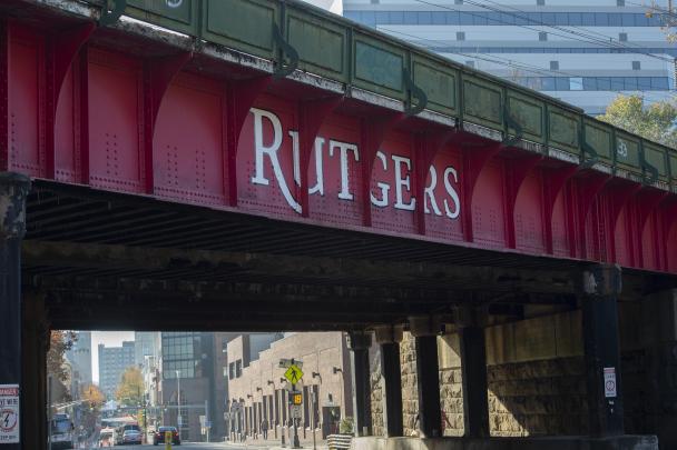 View of Northeast Corridor train bridge over George Street with Rutgers logo right outside the New Brunswick Station
