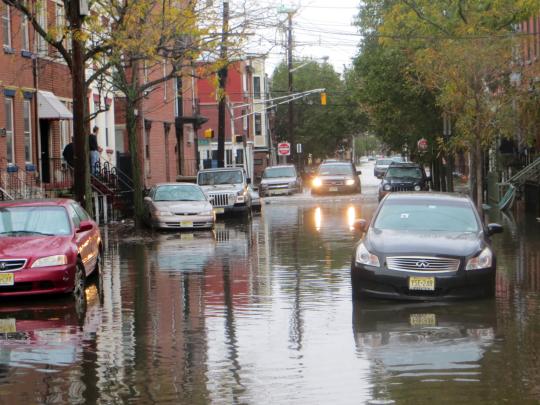 Hoboken residents drive through flooded streets after Superstorm Sandy.