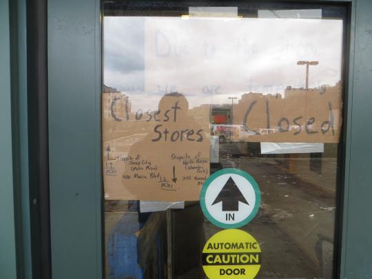 Signs on a grocery store door in Hoboken says closed due to Superstorm Sandy.