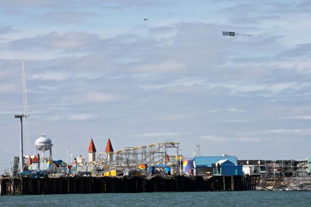 A plane pulling a banner that says "Jersey Strong" flies over Seaside Heights after Superstorm Sandy.