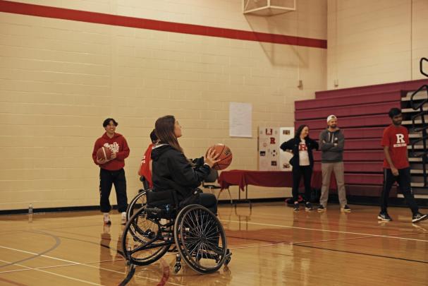 Students in wheelchairs play an adaptive form of basketball