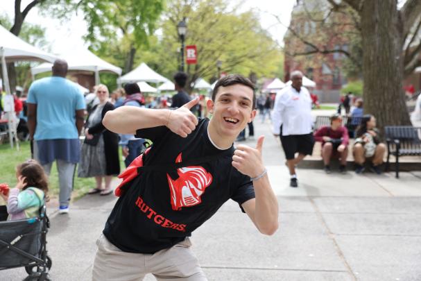An attendee gives thumbs up on Rutgers Day