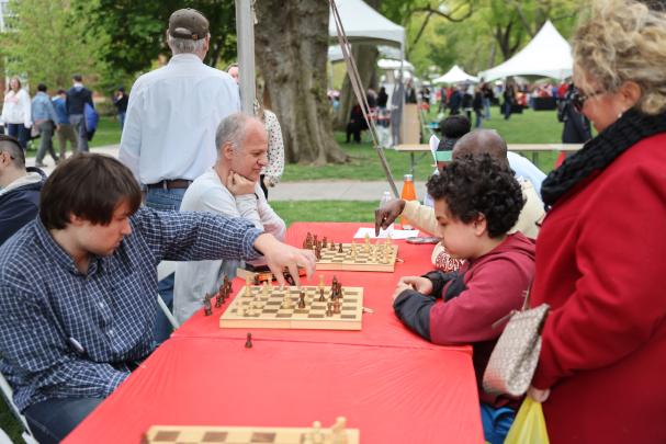 Attendees play chess on a table at Rutgers Day
